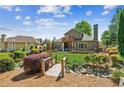 Expansive backyard featuring a wooden bridge, lush landscaping and a covered patio at 6382 Mountain Ridge Cir, Sugar Hill, GA 30518