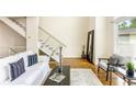 Bright living room featuring modern decor, hardwood floors, and a staircase at 1390 Stirling Nw Cir, Atlanta, GA 30318