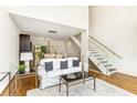 Living room with an open floor plan, a modern staircase, and hardwood floors at 1390 Stirling Nw Cir, Atlanta, GA 30318