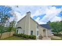 Side view of home with lawn, shrubbery, patio and rocking chairs at 156 Brookridge Ct, Douglasville, GA 30134