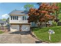 Charming two-story home with a well-manicured lawn and a decorative mailbox at 2099 Winsburg Nw Way, Kennesaw, GA 30144