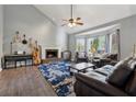 Bright living room featuring a cozy fireplace, vaulted ceiling, and a bay window at 2099 Winsburg Nw Way, Kennesaw, GA 30144