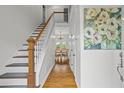 Welcoming foyer with hardwood floors, stairs leading to the second floor, and a dining area view at 2645 Sandstone Dr, Lawrenceville, GA 30043