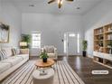 Bright living room with hardwood floors, vaulted ceilings, and a window offering natural light; virtually staged at 41 Olde Town Way, Rockmart, GA 30153