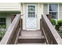 Inviting entrance with a wooden porch, a stylish white front door, and decorative wreath at 4424 Robinson St, Acworth, GA 30101