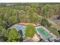Aerial view showcasing a community pool and tennis courts surrounded by lush trees and green spaces at 265 Valley Xing, Canton, GA 30114