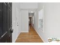 Welcoming foyer with hardwood floors, neutral walls, and natural light streaming through the nearby windows at 420 Eagle Tiff Dr, Sugar Hill, GA 30518