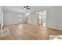 Bright living room with hardwood floors and a stairway visible, enhancing the open feel of the home at 420 Eagle Tiff Dr, Sugar Hill, GA 30518