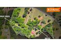 Aerial view showcases 8.2 acres with fruit trees, septic, lake access, and the home at 50 Silver Lake Dr, Mansfield, GA 30055
