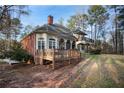 Back of house featuring a wooden deck, an outdoor living space, and a well-maintained yard at 175 Oak Manor, Fayetteville, GA 30214