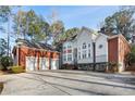 Large home with a three-car garage, a brick facade, and well-maintained landscaping at 175 Oak Manor, Fayetteville, GA 30214