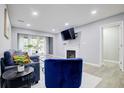 Well-lit living room with modern furniture, a mounted TV, and an open doorway at 24317 Plantation Ne Dr, Atlanta, GA 30324