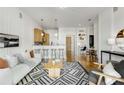 Bright and airy living room features hardwood floors, modern decor, and a kitchen area at 870 Inman Village Ne Pkwy # 305, Atlanta, GA 30307