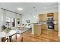 Sun-drenched living room with balcony access, open kitchen, and stylish furnishings at 870 Inman Village Ne Pkwy # 305, Atlanta, GA 30307