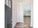 Inviting entryway featuring luxury vinyl plank flooring and neutral paint, leading to a bright, open living space at 2959 Rambler Dr, Loganville, GA 30052