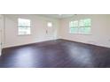 Bright living room with new, dark, wood-look flooring and fresh, neutral paint at 5170 2Nd St, Morrow, GA 30260
