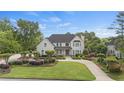 Beautiful two-story home with lush green lawn and meticulous landscaping at 9315 Prestwick Club Dr, Johns Creek, GA 30097