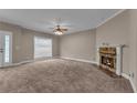 Spacious living room featuring plush carpeting, a cozy fireplace, and a large window for ample natural light at 1093 Third St, Stone Mountain, GA 30083