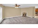 Open living area with fireplace, ceiling fan and view of the kitchen with stainless appliances and breakfast bar at 1093 Third St, Stone Mountain, GA 30083