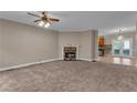 Cozy living room with a charming fireplace and an open view leading to the kitchen with stainless steel appliances at 1093 Third St, Stone Mountain, GA 30083