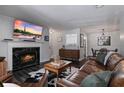 Bright living room with a fireplace, hardwood floors, and an open layout at 401 Berkeley Woods Dr, Duluth, GA 30096