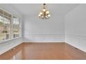 Bright dining room featuring hardwood floors, decorative moldings, and stylish chandelier at 4915 Bergen Ct, Cumming, GA 30040
