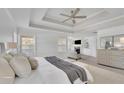 Spacious main bedroom features a trey ceiling, fan, sitting area and modern decor at 4915 Bergen Ct, Cumming, GA 30040