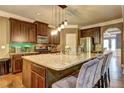 Kitchen showcasing large island with granite countertop, wood cabinets, and stainless fridge at 5280 Clingman Ct, Douglasville, GA 30135