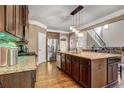 Gourmet kitchen with island, stainless steel fridge, granite countertops and wood floors at 5280 Clingman Ct, Douglasville, GA 30135