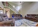 Cozy living room with hardwood floors, comfortable seating, and staircase access at 5280 Clingman Ct, Douglasville, GA 30135