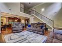 Spacious living room featuring hardwood floors, a staircase, and comfortable seating at 5280 Clingman Ct, Douglasville, GA 30135