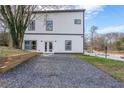 Modern home showing the gravel driveway, two-story elevation and simple, dark-framed window trim at 125 Laurel Sw Ave, Atlanta, GA 30314