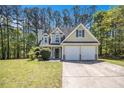Charming two-story home with a well-manicured front yard and two-car garage at 432 Tanner Farm Dr, Rockmart, GA 30153