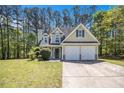 Charming two-story home with a manicured lawn and attached two-car garage at 432 Tanner Farm Dr, Rockmart, GA 30153
