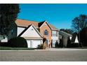 Traditional home with a well-maintained lawn, a brick facade, and a two-car garage at 4406 Dickens Nw Ct, Kennesaw, GA 30144