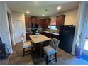 Eat-in kitchen includes an island, granite countertops, and dark wood cabinets at 5903 El Segundo Way, Atlanta, GA 30349