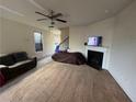 Cozy living room features neutral walls, a fireplace, and a ceiling fan at 5903 El Segundo Way, Atlanta, GA 30349