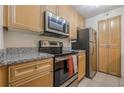 Well-lit kitchen showcases stainless appliances, granite countertops and wood cabinetry at 3203 Lenox Ne Rd # 32, Atlanta, GA 30324