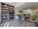 Cozy living room featuring hardwood floors, a built-in bookshelf, and a comfortable sectional sofa at 3203 Lenox Ne Rd # 32, Atlanta, GA 30324