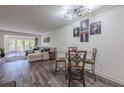 Inviting living room with hardwood floors, dining table, light fixture, and comfortable sofa at 3203 Lenox Ne Rd # 32, Atlanta, GA 30324