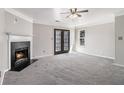 Spacious living room featuring a fireplace, neutral carpet, and glass doors leading to outdoor space at 89 Bridge View Dr, Marietta, GA 30066
