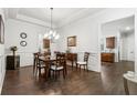 Formal dining room featuring hardwood floors, wainscoting, and an elegant chandelier at 1227 Magnolia Path Way, Sugar Hill, GA 30518
