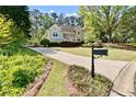 Landscaped front yard and long driveway to a charming, traditional home at 1315 Pembridge Nw Way, Kennesaw, GA 30152