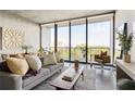 Cozy living room with large windows, city view, comfortable seating, and stylish decor at 480 John Wesley Dobbs Ne Ave # 716, Atlanta, GA 30312