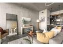 Stylish living room featuring modern furnishings, concrete walls, and an open layout at 480 John Wesley Dobbs Ne Ave # 716, Atlanta, GA 30312