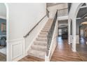 Elegant staircase with wrought iron railings and hardwood floors at 975 Matt Springs Ct, Lawrenceville, GA 30045