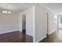 Dining area features dark wood floors, white trim and paint, along with a modern light fixture at 12495 Concord Hall Dr, Alpharetta, GA 30005