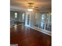 Bright open living room with hardwood floors, ceiling fan and large window at 2570 Treasure Ct, Decatur, GA 30034