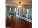 Open living room featuring hardwood floors, fan, and ample natural light at 2570 Treasure Ct, Decatur, GA 30034