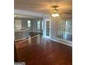 Open living room featuring hardwood floors, fan, and ample natural light at 2570 Treasure Ct, Decatur, GA 30034